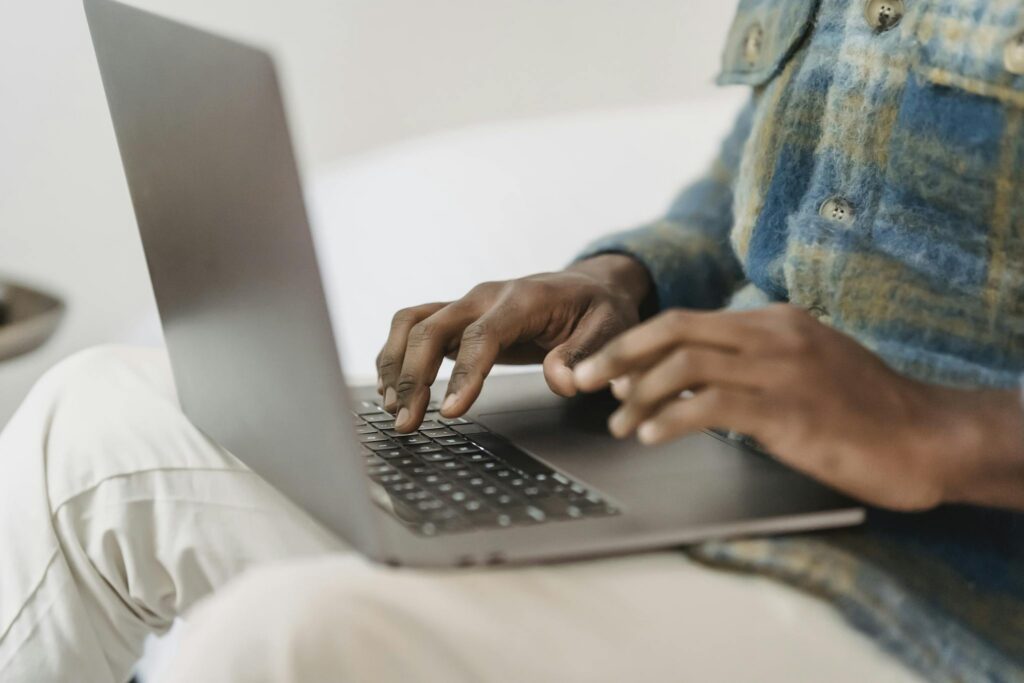 African American man in casual clothes using laptop